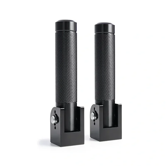 A pair of Macfox X1S Rear Pegs, black metal handle attachments with textured grips and rectangular bases, are displayed upright on a white background.