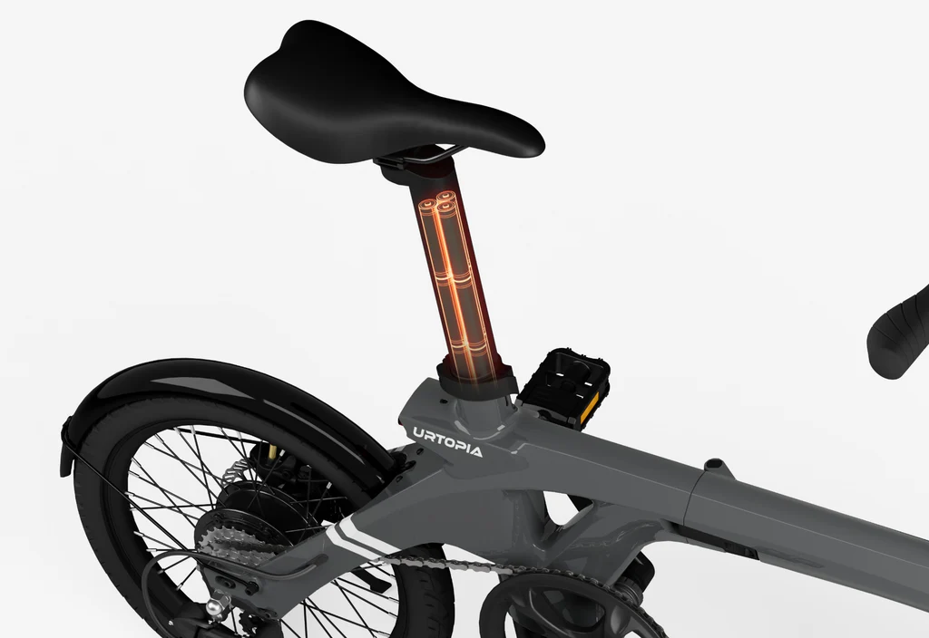 A close-up of the Urtopia Carbon Fold 1 eBike’s gray seat post, showing an illuminated battery compartment beneath the saddle.