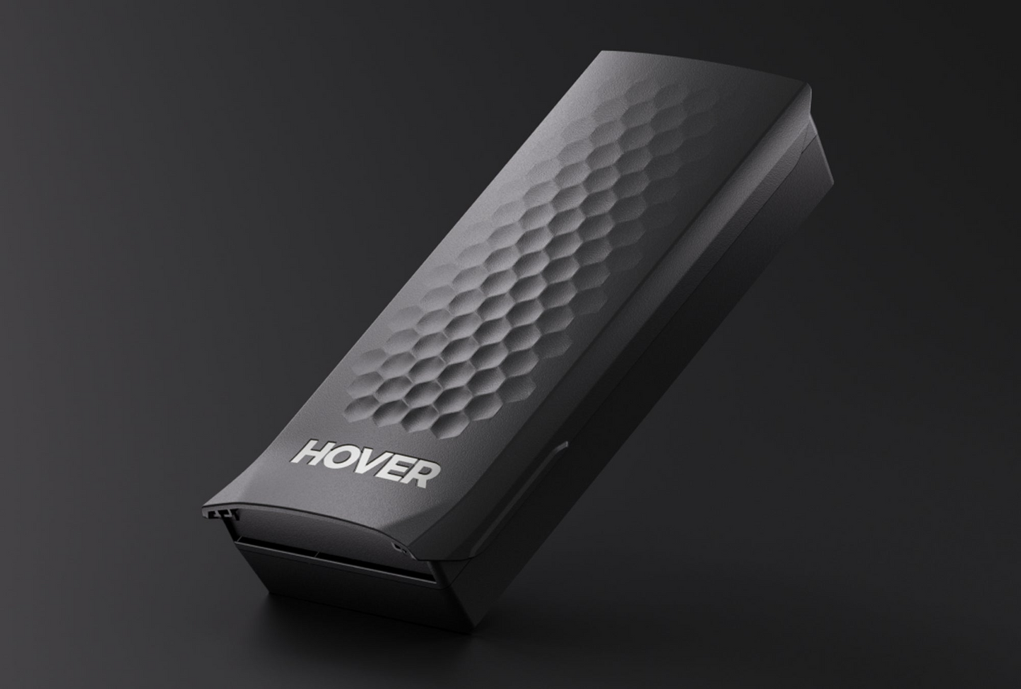 Against a dark backdrop, the black HOVERAir X1 PRO Smart Battery with a honeycomb texture prominently features "HOVERAir." Designed for eBikes & Scooters, it can also integrate seamlessly using a handlebar mount.