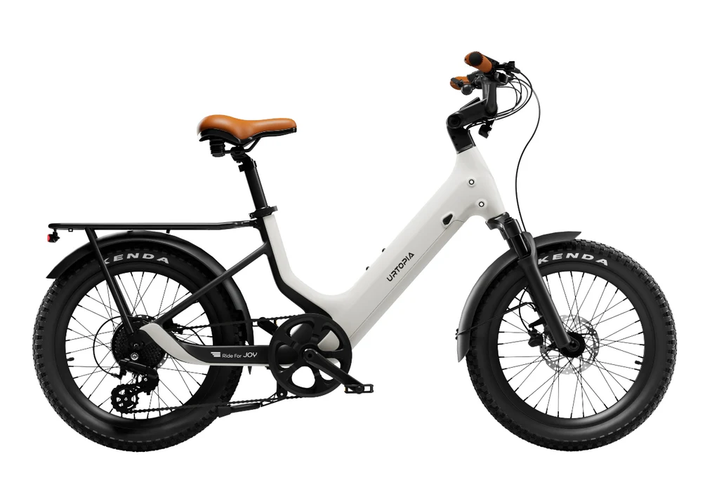 The Urtopia - Joy Carbon by Urtopia, a white Step-Thru eBike with fat tires, rear cargo rack, and stylish brown saddle and handlebar grips, is displayed against a plain white background.