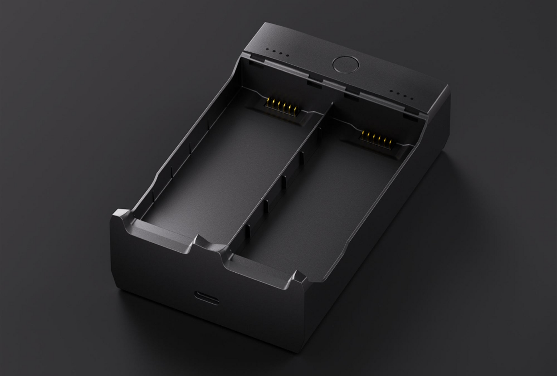 The HOVERAir Charging Hub, a dual-slot black charger, sits on a dark surface and features a USB port with LED indicators for efficient management.