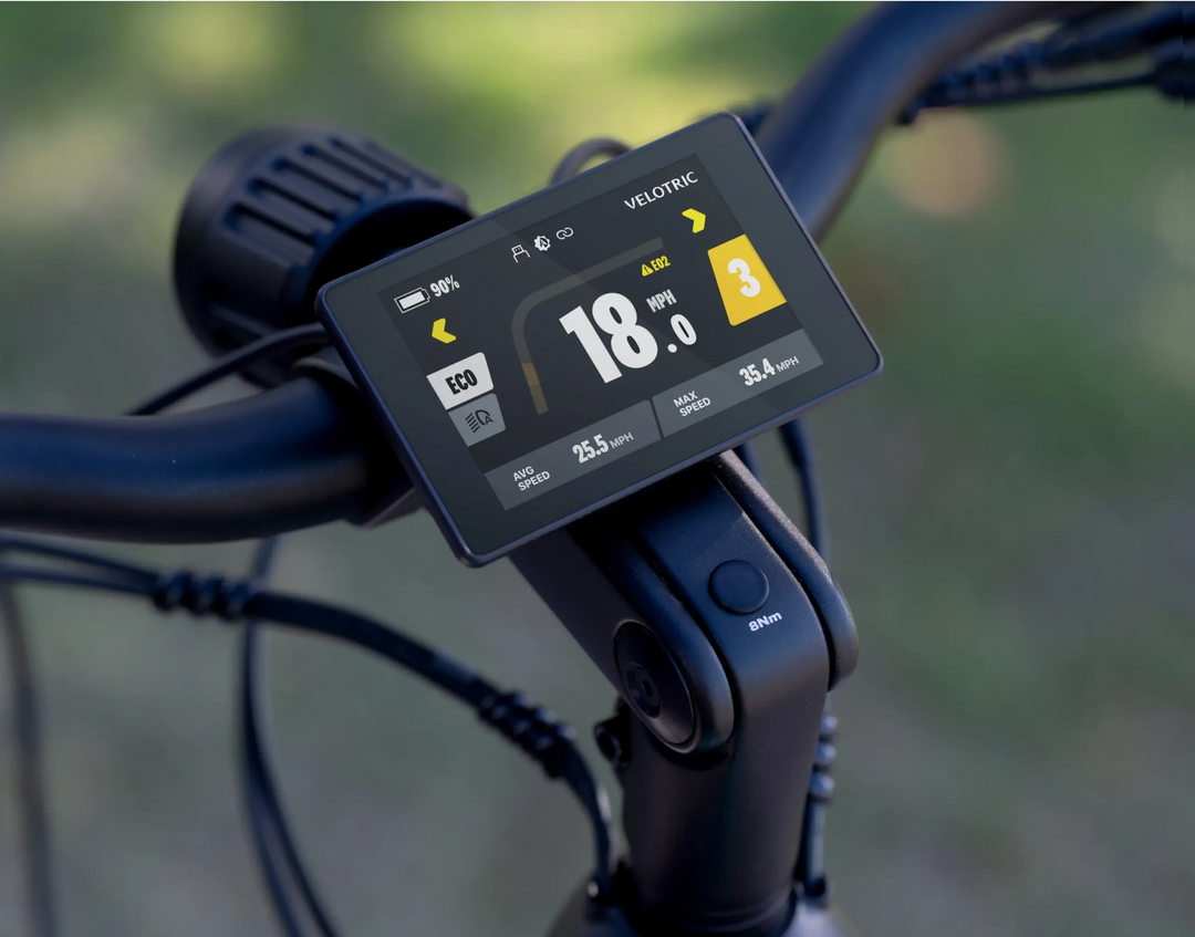 Close-up of a Velotric Discover 1 display showing speed at 18.0 mph, battery at 80%, odometer at 25.5 miles, range at 35.4 miles, and the bike set to assist level 3. Experience Tampa Bay eBikes with this top-notch electric bike for a smooth ride through the city.