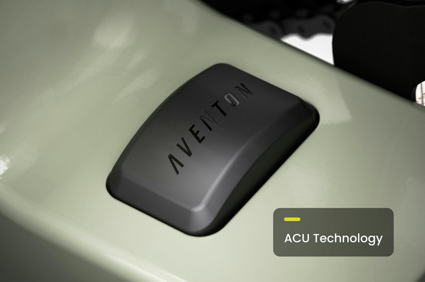 Close-up of a black "AVENTON" component on the light green Aventon Abound LR cargo e-bike, featuring a graphic overlay that reads "ACU Technology.