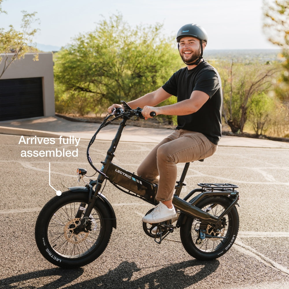 A rider in casual clothes and helmet cruises on a Lectric - XP4 folding eBike with a 750W rear hub motor; the image displays the text, "Arrives fully assembled.