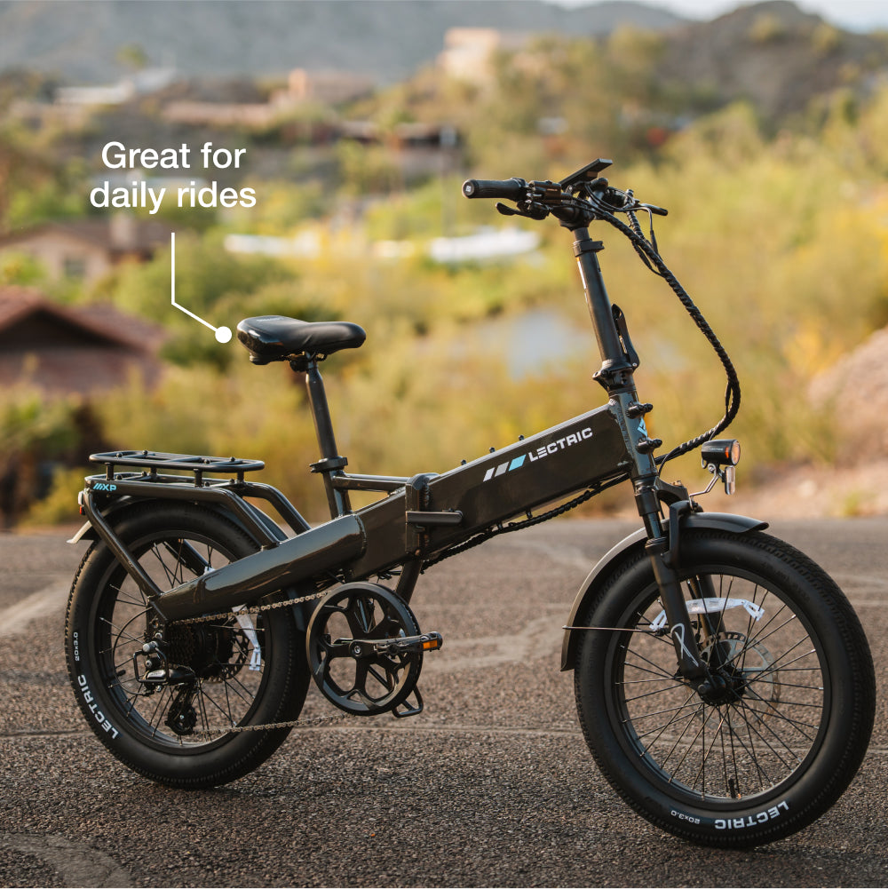 A black Lectric XP4 folding eBike with a 750W rear hub motor is parked outdoors on pavement. A label points to the seat, stating "Great for daily rides.