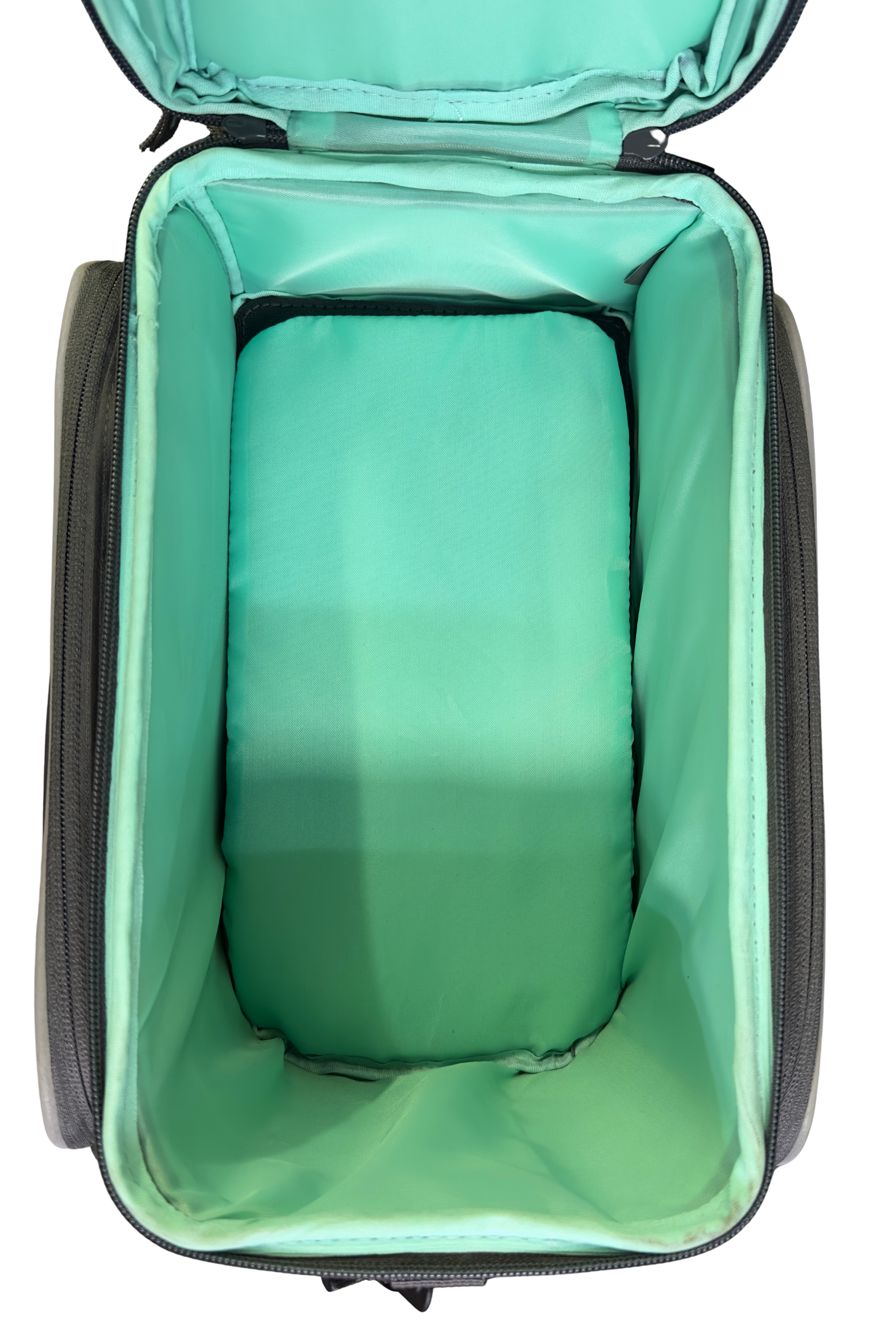 An open, empty suitcase with a light green interior lining is shown from a top-down view, resembling the spacious design of the Basil Sport Design MIK Bag in Graphite & Mint by Basil.