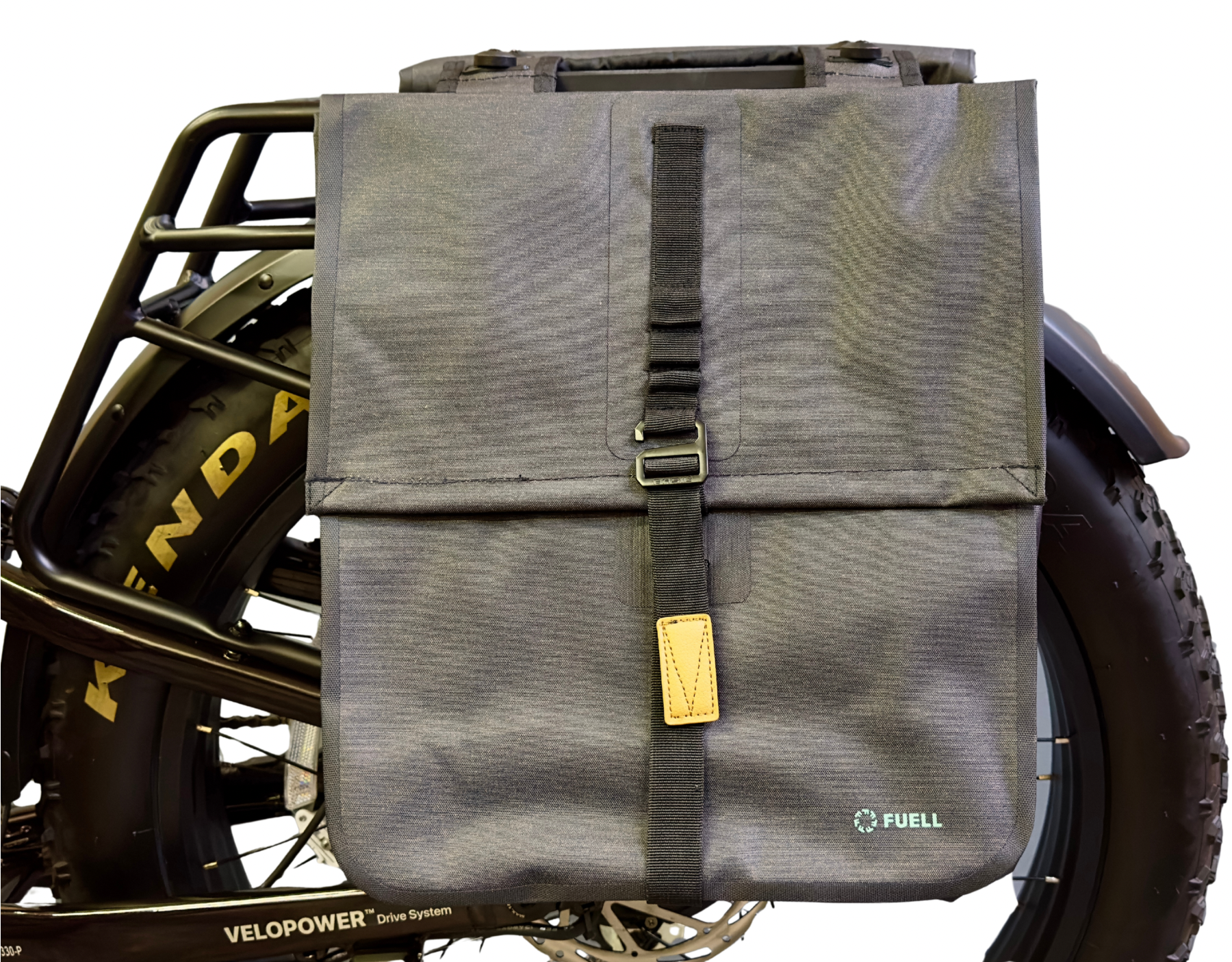 A Basil Urban Dry MIK Double Pannier is attached to the side of a black bicycle with fat Kenda tires and a Velopower drive system.