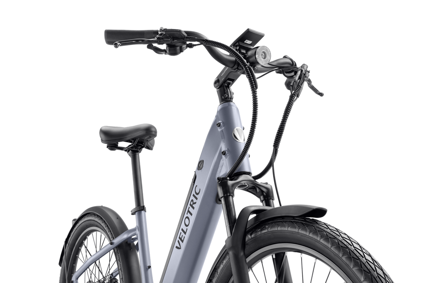 Close-up view of a Velotric - Discover 1 Plus commuter e-bike featuring a grey frame, black tires, a cushioned saddle, handlebar-mounted controls, and the powerful Velopower H50 drive system.