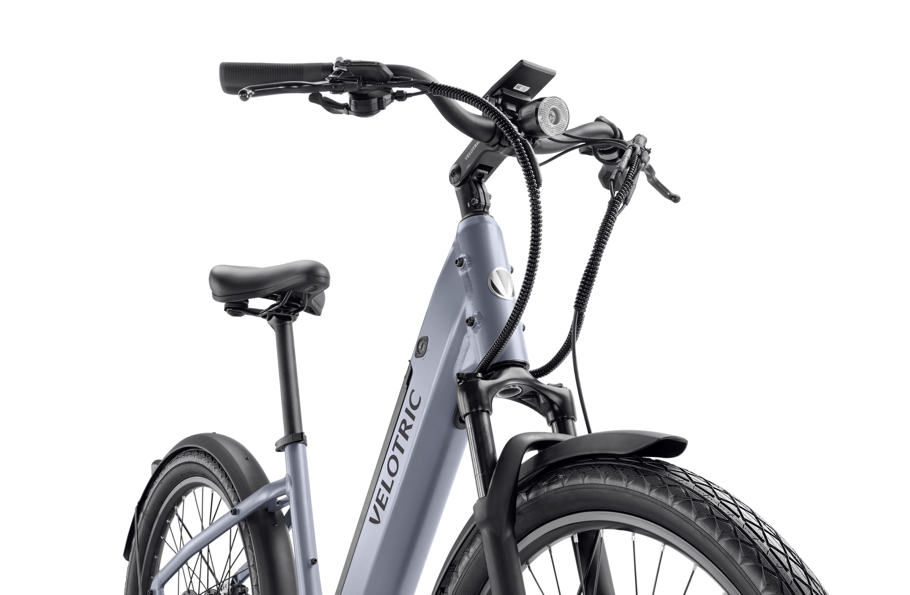 Close-up view of a Velotric - Discover 1 Plus commuter e-bike featuring a grey frame, black tires, a cushioned saddle, handlebar-mounted controls, and the powerful Velopower H50 drive system.