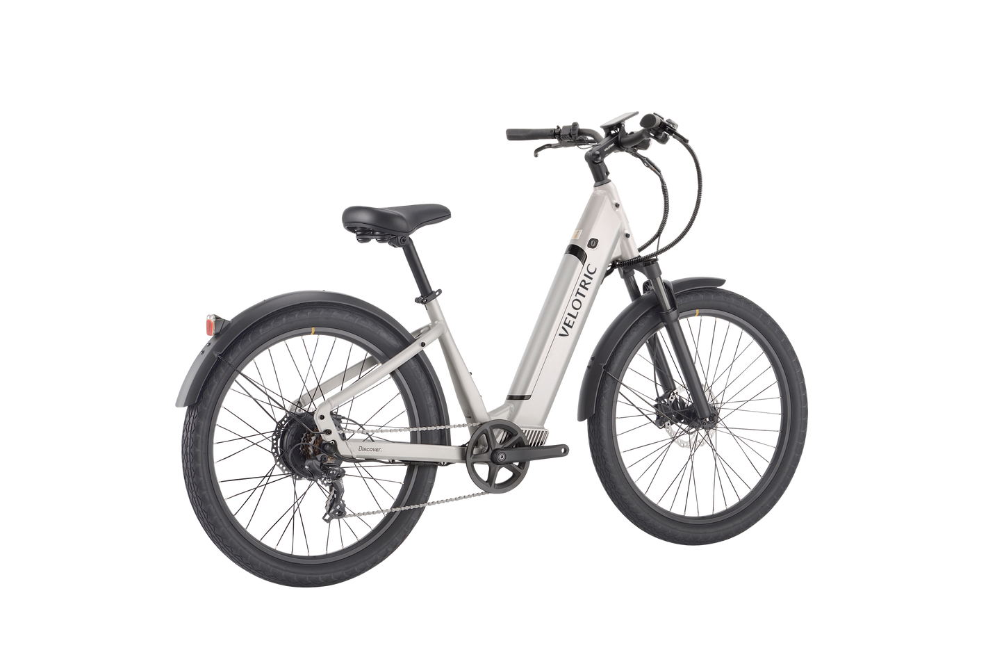 A white commuter e-bike with thick tires, a black saddle, and a front suspension fork. The words "Velotric - Discover 1 Plus" are printed on the down tube. Featuring a powerful Velopower H50 drive system, the bike also has a rear rack and disc brakes.