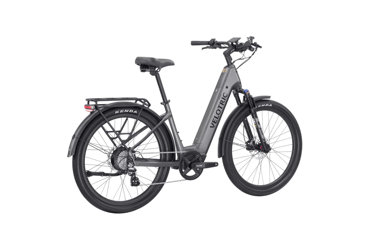 The Velotric - Discover 2, offered by Tampa Bay eBikes, is a gray eBike with a rear cargo rack and large black tires. Featuring advanced eBike engineering, it boasts a front suspension fork, mid-drive motor, and disc brakes for superior performance.
