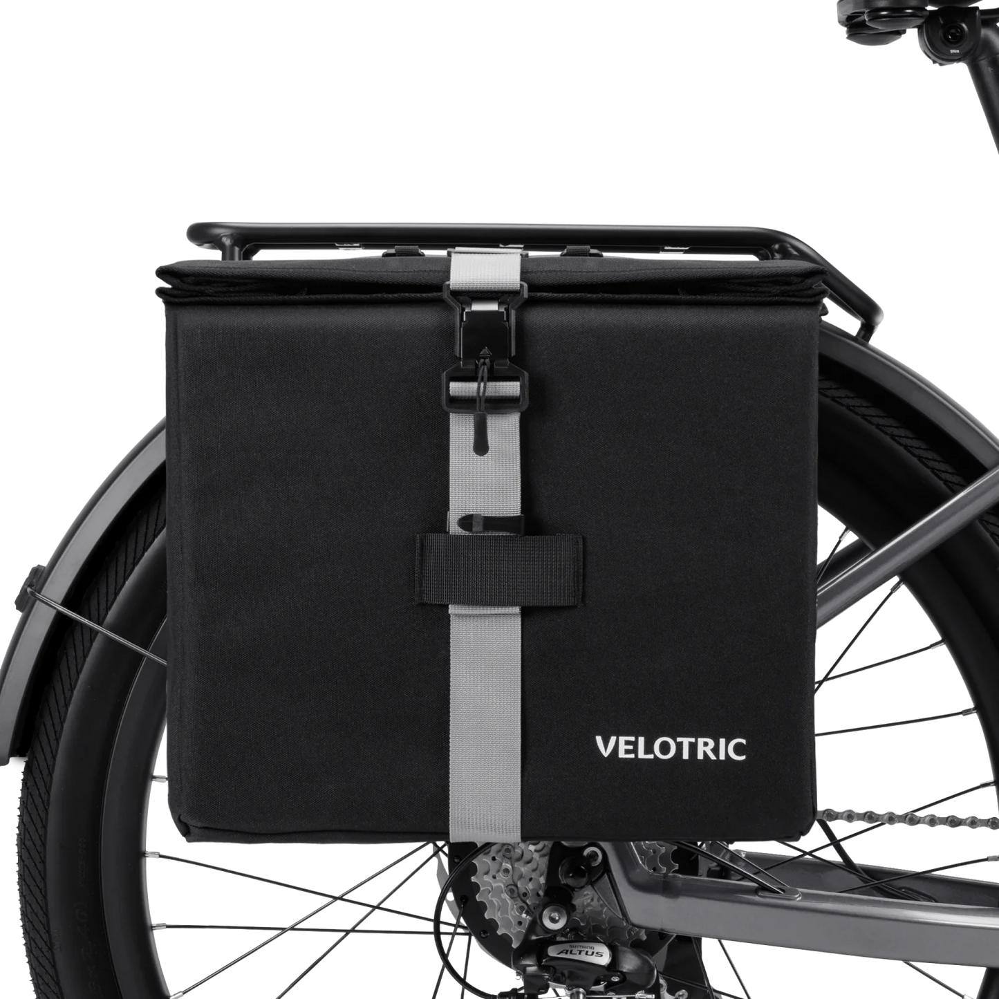 The Velotric - Rear Rack Pannier Bag by Velotric, in black with a gray front strap and buckle, is mounted on your eBike’s rear rack, providing waterproof utility for your rides.