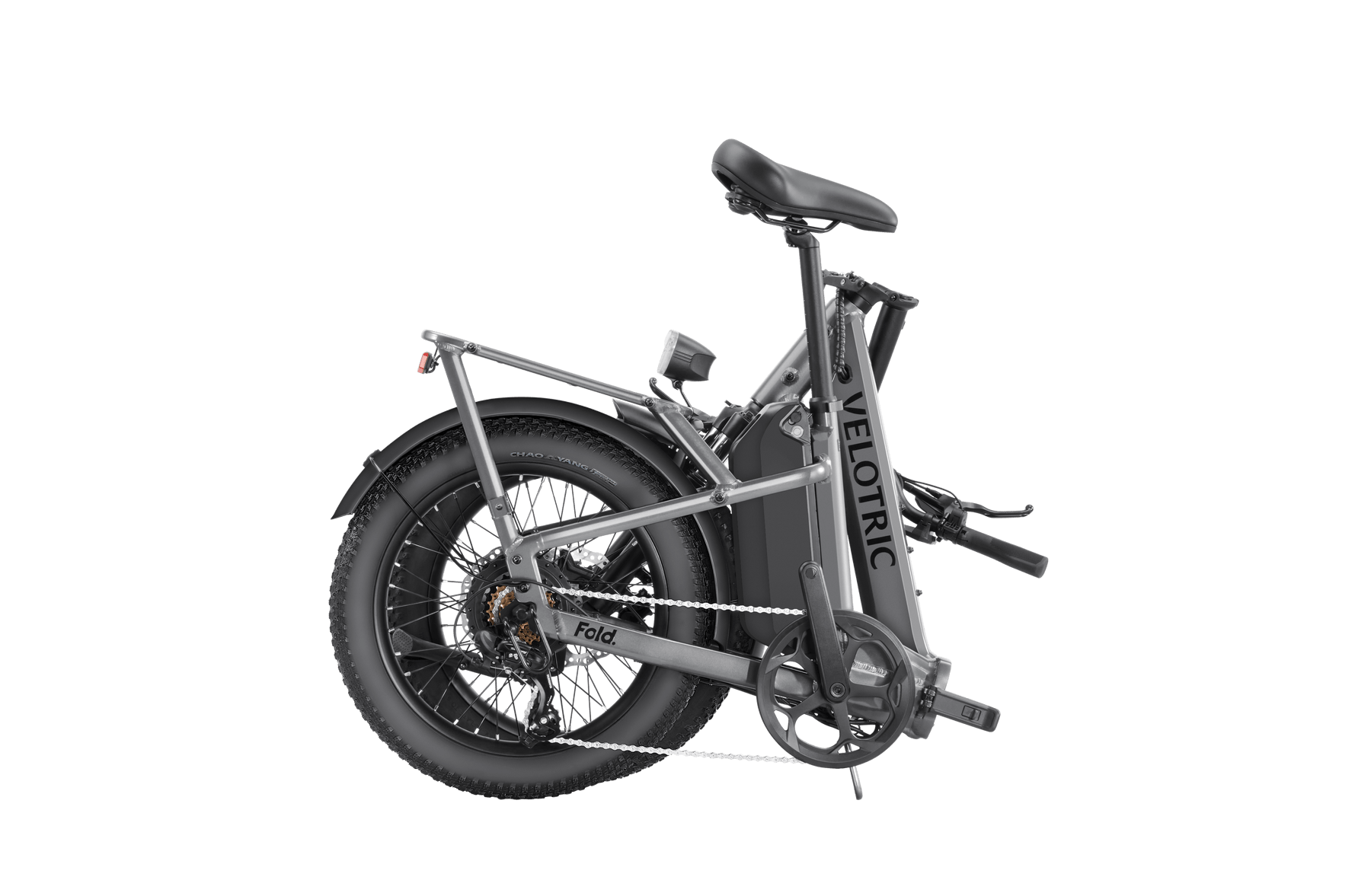 A compact, folded Velotric - Fold 1 eBike with thick tires and a rear suspension, displayed against a solid grey background.