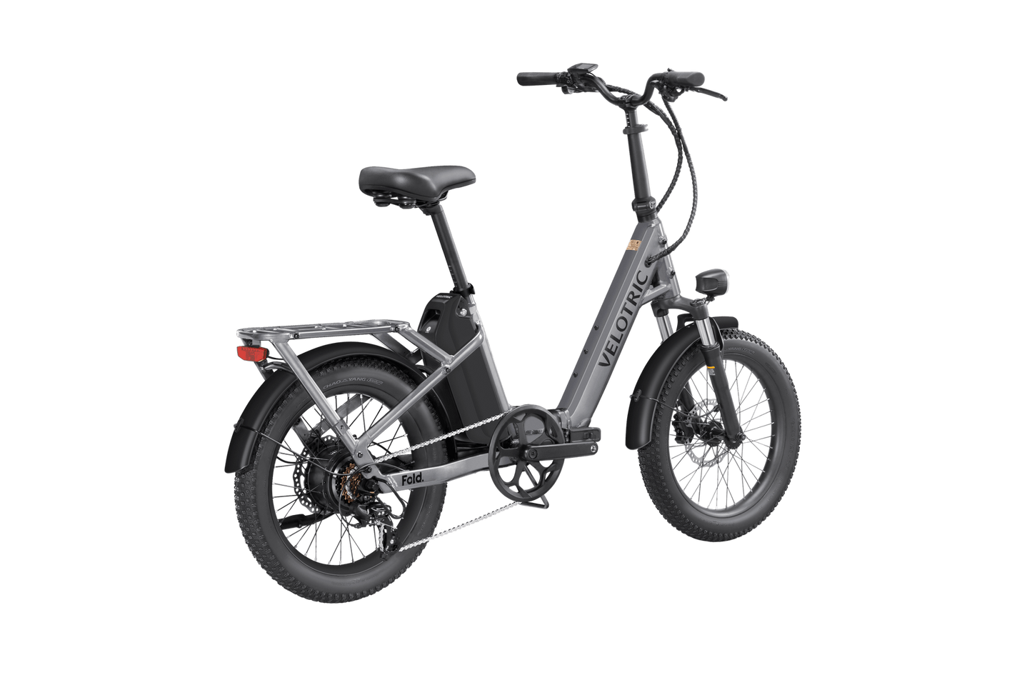 Velotric - Fold 1 electric folding eBike with thick tires, a hydraulic suspension, and a rear rack, displayed on a plain dark background.