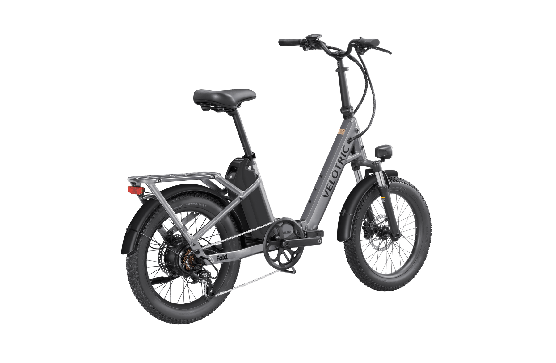 Velotric - Fold 1 electric folding eBike with thick tires, a hydraulic suspension, and a rear rack, displayed on a plain dark background.