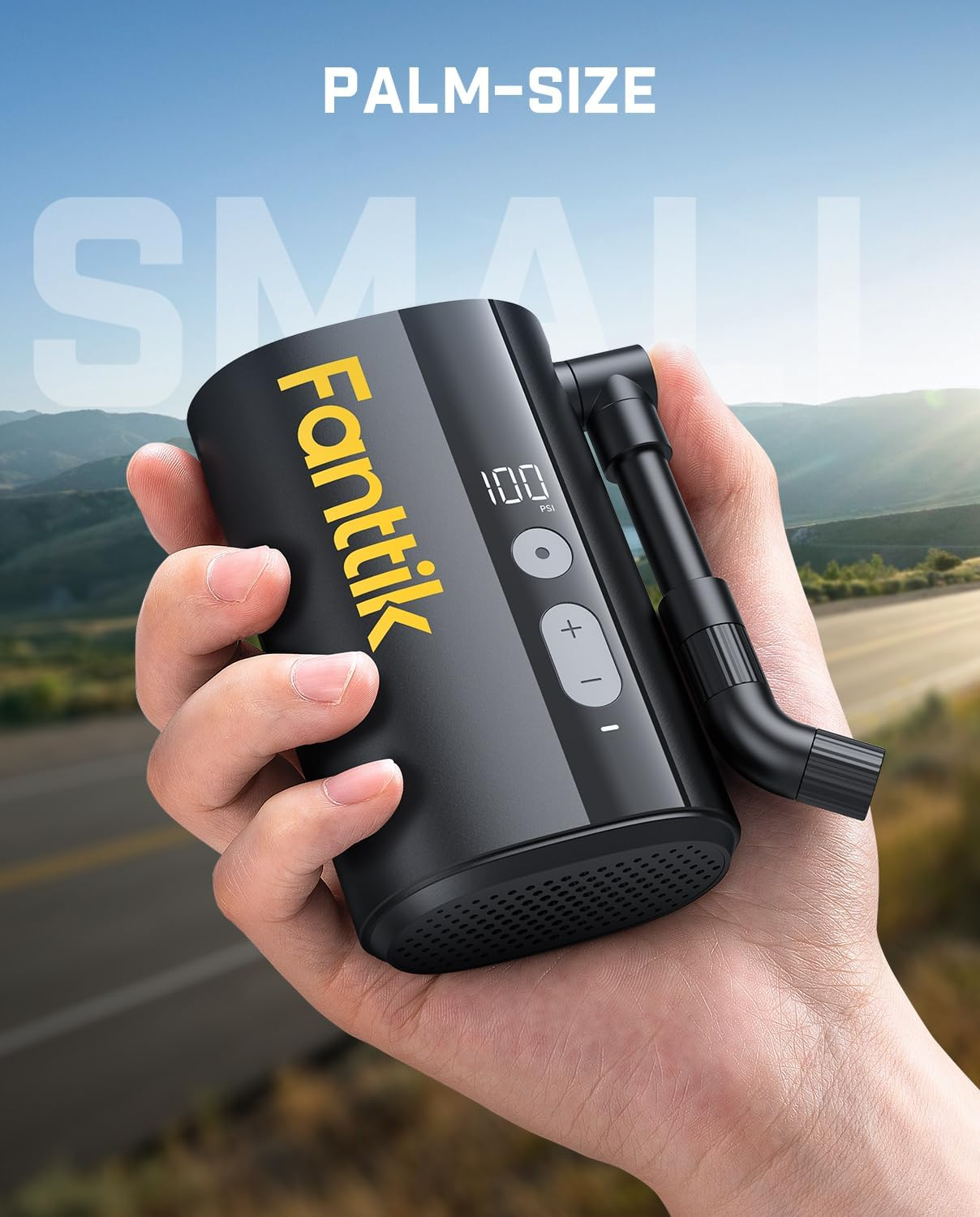 A hand holds the Fanttik X9 Ace Mini Air Pump, a compact black device with a digital display, buttons, and nozzle labeled "palm-size," set against a blurred outdoor background.