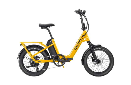 The Velotric - Fold 1 Plus electric bike has a powerful motor, black seat, handlebars, and tires. This foldable eBike includes a rear rack and a convenient low step-through frame.