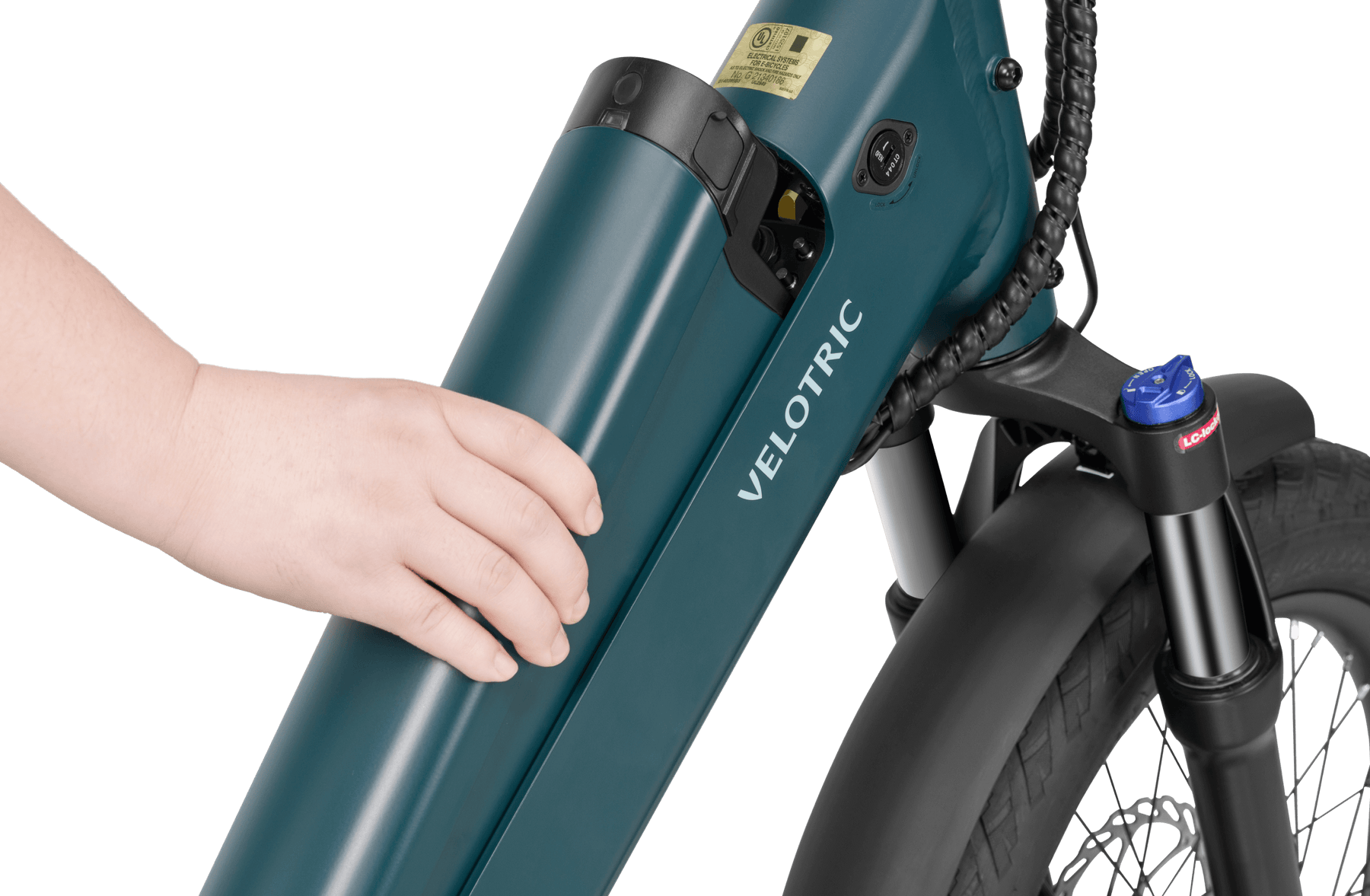 Close-up view of a person's hand inserted into a lock on the battery unit of a teal-colored Velotric Go 1 electric bike.