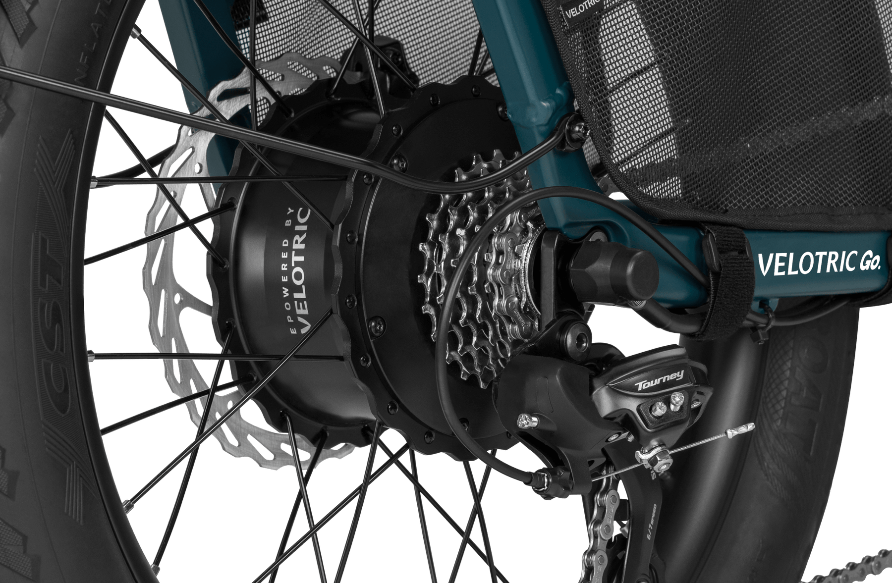 Close-up of a Velotric Forest electric bicycle’s rear wheel, showcasing the hub motor, Shimano Tourney derailleur, and disc brake.