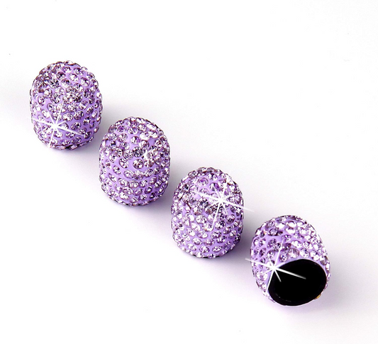 Four Color Splash Valve Gems - Amethyst are arranged in a row on a white background; one is open, revealing its dark interior. Each sparkling purple cap is studded with rhinestones.