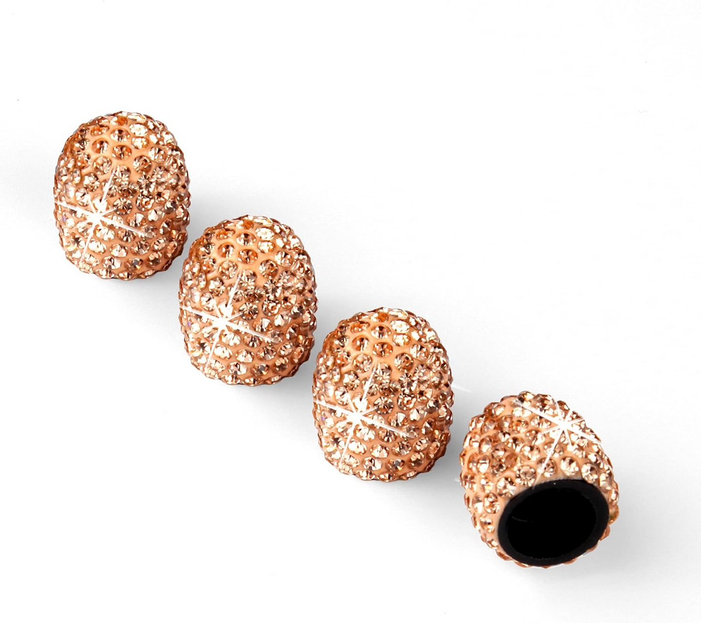 Four Color Splash Valve Gems - Gold, textured oval-shaped bike valve stem caps, are arranged in a row on a white background, with one cap displaying its open end.