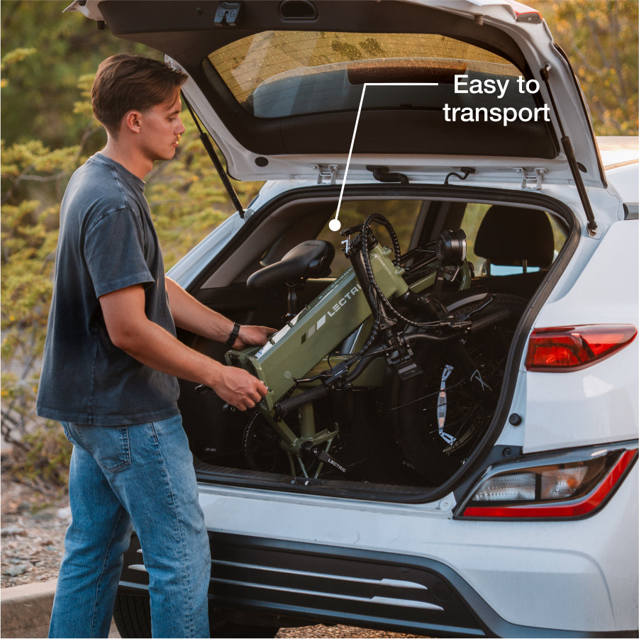 A person loads a folded Lectric XP4 green electric bike into a white SUV trunk. A label reads "Easy to transport." The Lectric XP4 features advanced Torque Sensor Technology for smooth, efficient rides.