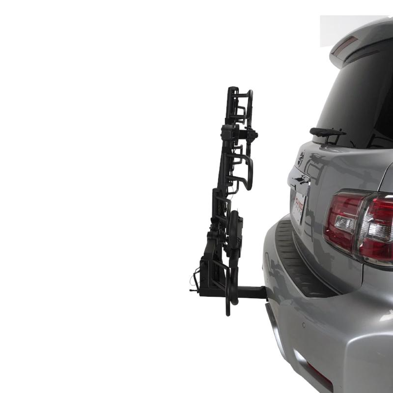 A silver SUV with a Hollywood Racks - Sport Rider SE4 bike rack attached to the back, offering ease of use for transporting bicycles.