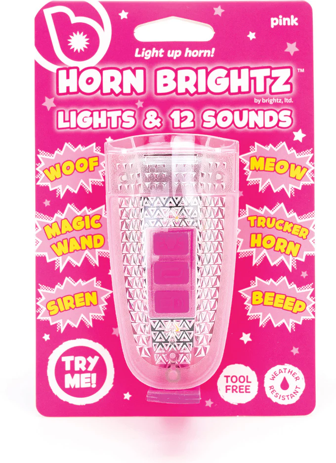 A pink Horn Brightz bicycle accessory by Brightz in packaging, with an LED light and 12 fun sounds like woof, meow, and siren. The package features "Try Me!" and "Tool Free" labels for easy setup.