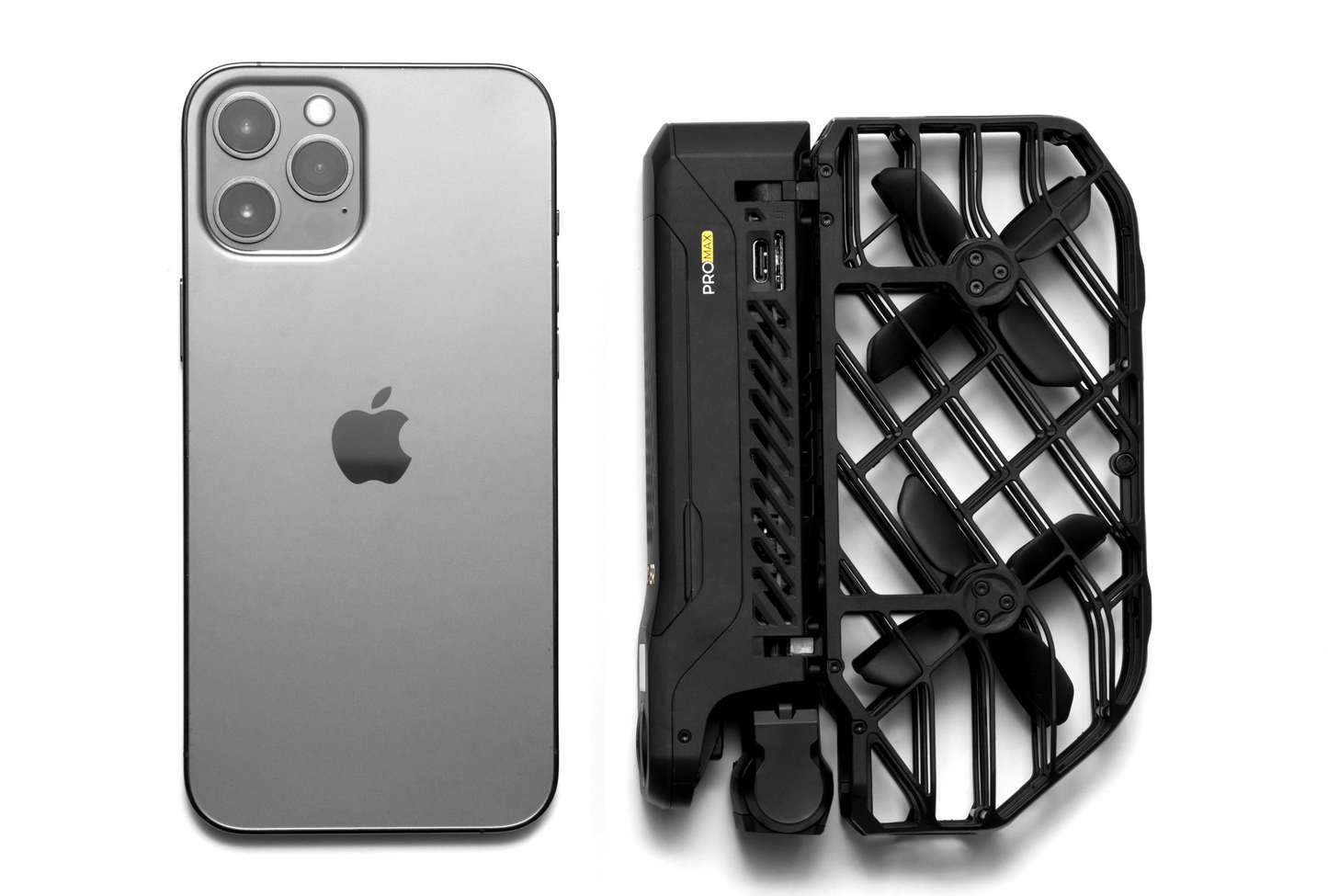 A smartphone with a triple camera setup sits beside the compact HOVERAir X1 Pro Max, a foldable drone by HOVERAir featuring AI tracking and self-flying camera capabilities for seamless aerial photography.