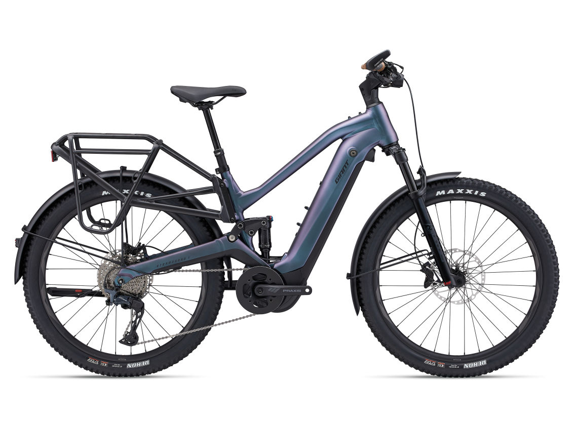 The Giant Stormguard E+ 1, a modern SUV eBike by Giant, features a step-through frame, powerful motor, front suspension, rear cargo rack, and thick Maxxis tires—shown from the side against a white background.