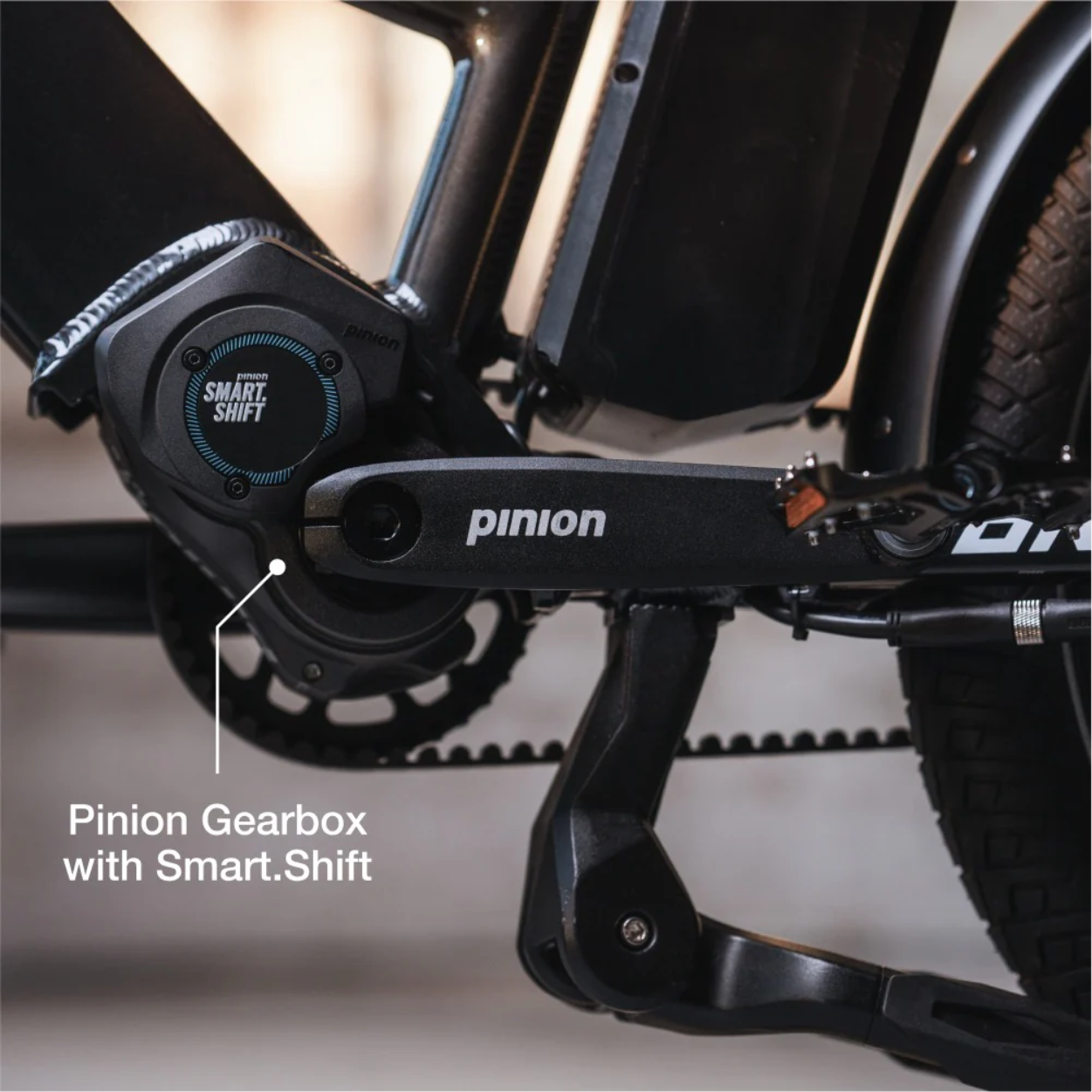 Close-up of the Lectric - ONE’s Pinion Gearbox with Smart.Shift technology, displaying the crank arm, pedals, and part of the frame near the drivetrain.