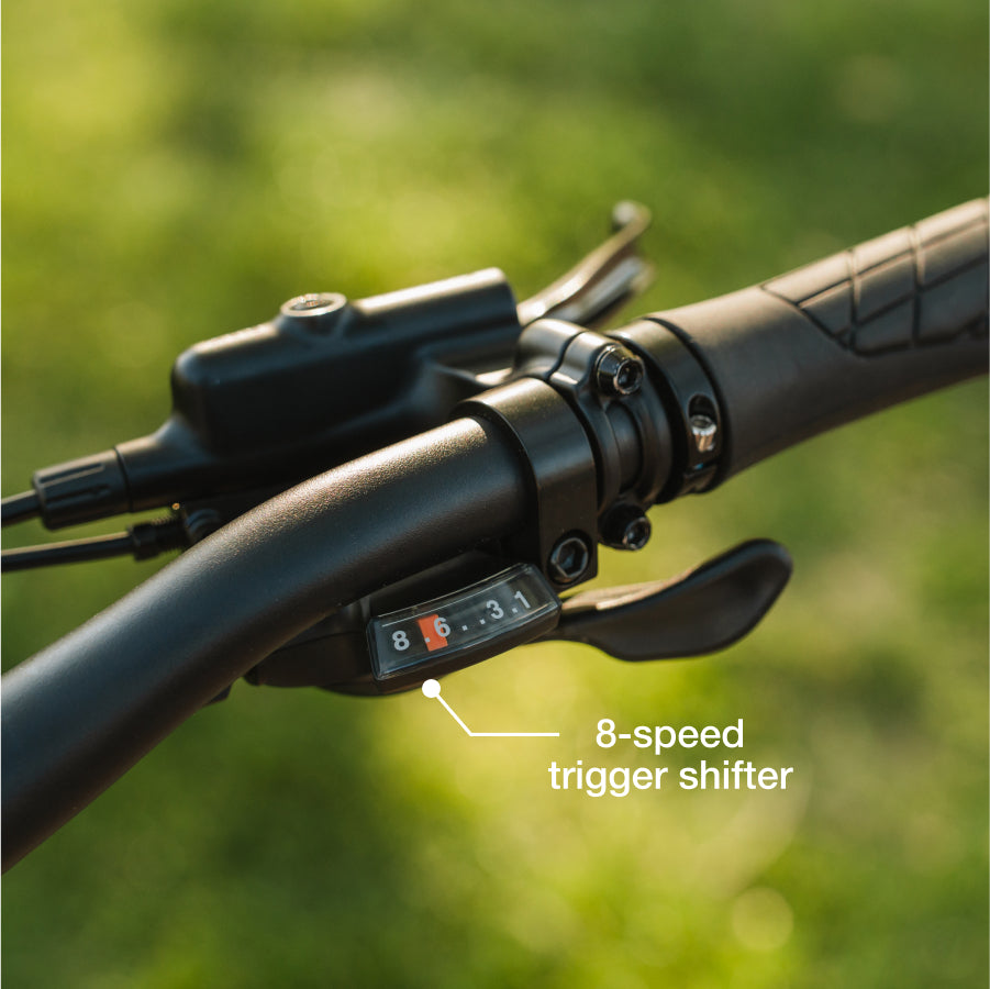 Close-up of the Lectric - XP4 folding eBike handlebar, showcasing its 8-speed trigger shifter and labeled gear indicator.
