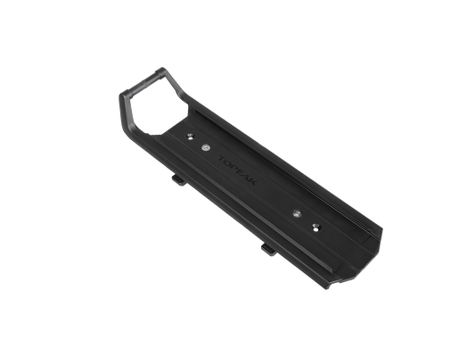 The black plastic mount, branded with "Omni" on its surface, is designed for seamless integration with TrunkBags or rear baskets. This sturdy accessory also includes the OMNI QUICKTRACK ADAPTER to ensure quick and secure attachment.