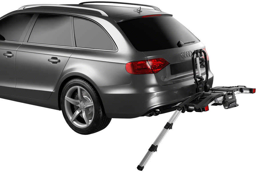 A Thule EasyFold XT Hitch Bike Rack efficiently folded on a gray station wagon for transporting e-bikes.