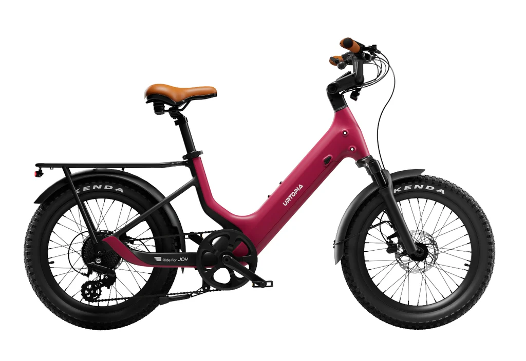 The Urtopia Joy Carbon by Urtopia is a red e-bike with a step-through frame, black wheels, brown saddle and handlebars, rear cargo rack, thick Kenda tires, and a sleek Smartbar, shown on a white background.
