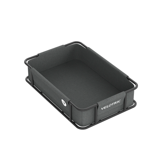 A large volume Velotric rear basket with a waterproof fabric, displayed on a black tray on a black background.