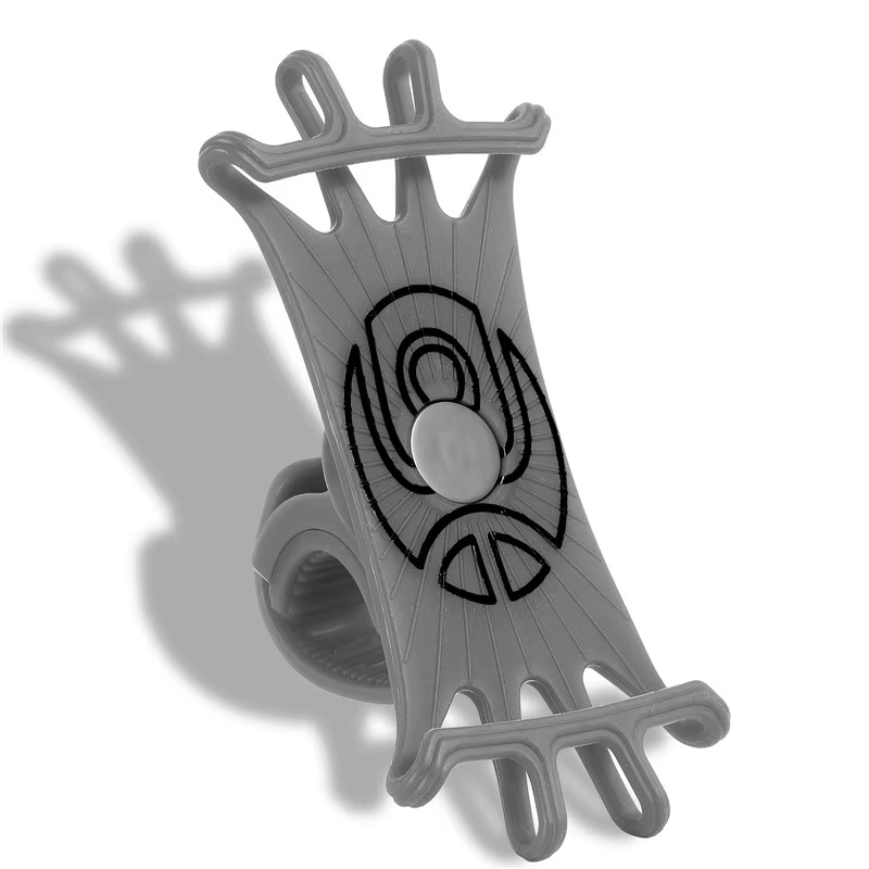 The Cell Phone Holder - Stretch by Tampa Bay eBikes features a gray silicone design with stretchable straps and a circular center. It stands upright, casting a shadow on a white background. This versatile holder ensures wide phone compatibility for your device's needs.