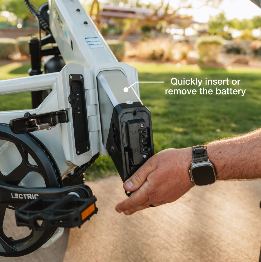 A person’s hand inserts or removes the battery from the Lectric XP4 Folding eBike, with text reading "Quickly insert or remove the battery.