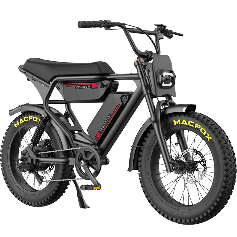 The Macfox - X2, a black e-bike with fat tires, a rectangular seat, headlights, and yellow "MACFOX" branding on the tires, is displayed against a plain white background.