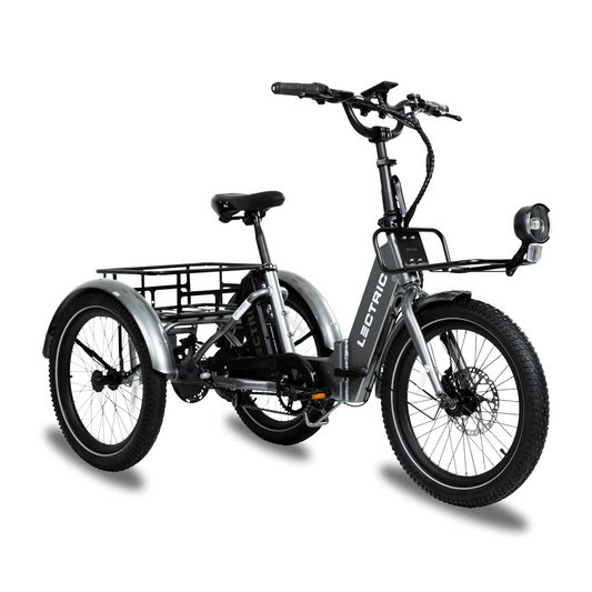 The Lectric XP Trike is a foldable electric tricycle by Lectric, featuring a front headlight, wide tires, rear hub motor, hydraulic brakes for safety, and a sturdy frame with a rear cargo rack for utility and stability in various tasks.