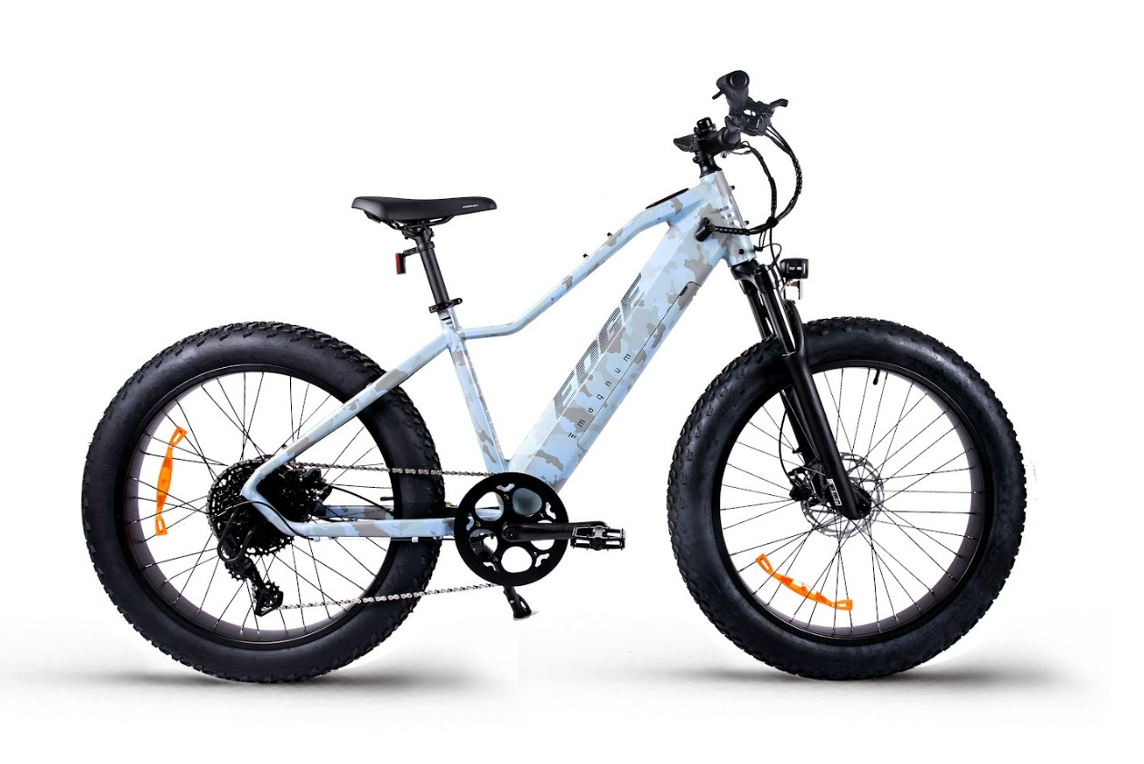 The Magnum - Edge by Tampa Bay eBikes is a white fat-tire mountain eBike with a slanted top tube, front suspension, and disc brakes, displayed from the side against a white background.