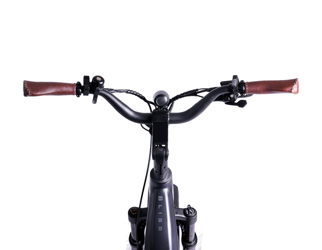 Front view of the Magnum - Bliss electric bike by Tampa Bay eBikes, featuring brown leather grips, black cables, and "BLISS" on the stem, highlighting its powerful motor and long range against a white background.