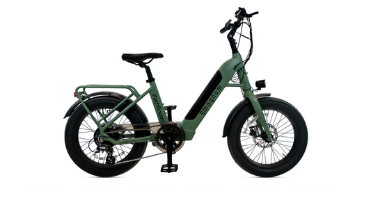 Side view of the Magnum - Pathfinder 350 by Magnum, a green fat tire e-bike with thick tires, step-through frame, front suspension fork, rear rack, and disc brakes, shown on a white background.