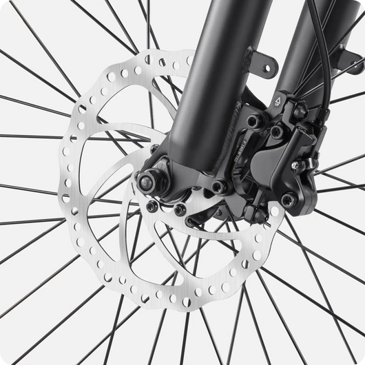 Close-up of a Velotric Fold 1 bicycle disc brake and front wheel assembly, focusing on the rotor and fork details.