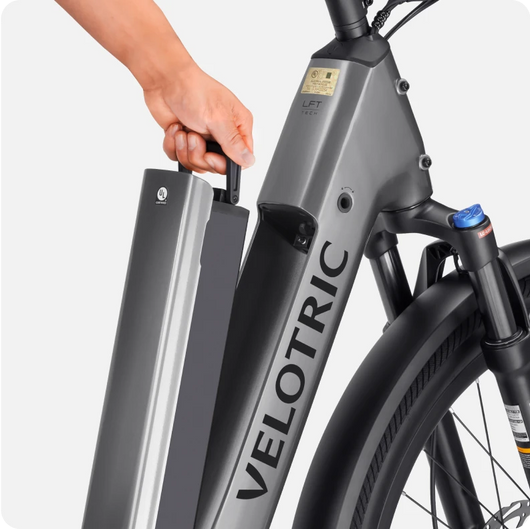 A hand removing the battery from a Velotric - Discover 2, showcasing advanced eBike engineering. Available at Tampa Bay eBikes.