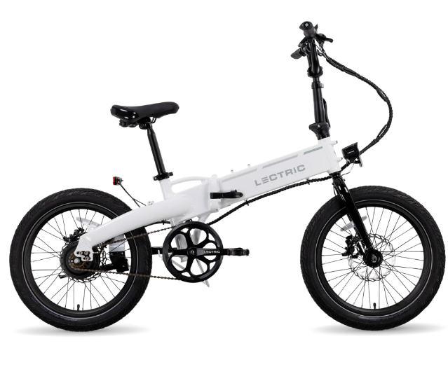 The Lectric - XP Lite 2.0 is a stylish white folding eBike with a black seat and handlebars, featuring pedal-assist and visible wiring for convenient urban commuting.