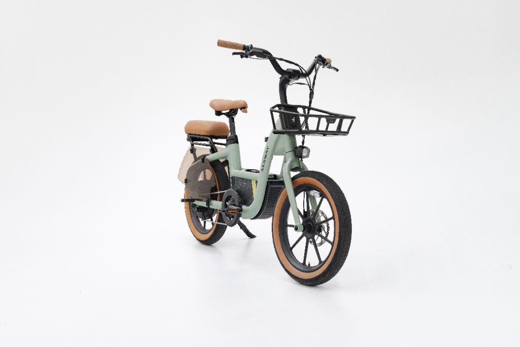 A Segway Muxi electric utility bike by Segway, featuring light green color, tan seat and grips, front basket, and black accents, shown on a plain white background.