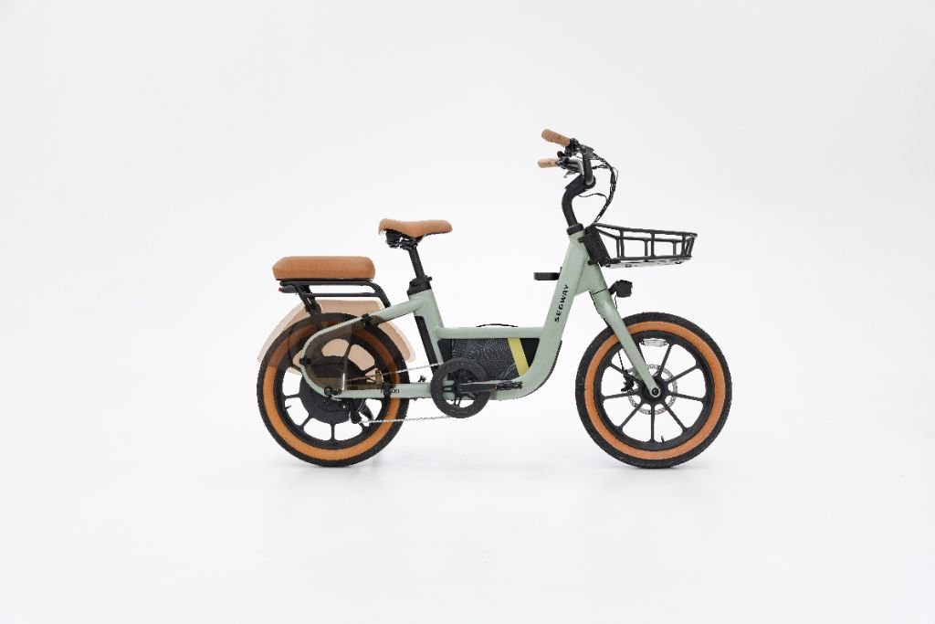The Segway Muxi electric utility bike by Segway features a light green frame, tan seat, backrest and grips, black front basket, and tan-trimmed tires, displayed on a plain white background.