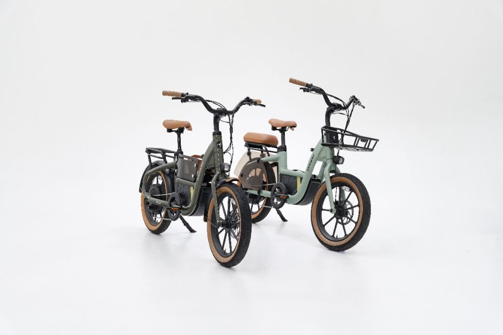 Two Segway Muxi electric bikes with tan seats and tires are side by side on a white background; one 750W Segway eBike includes a front basket, making it ideal as a family utility bike for daily errands.