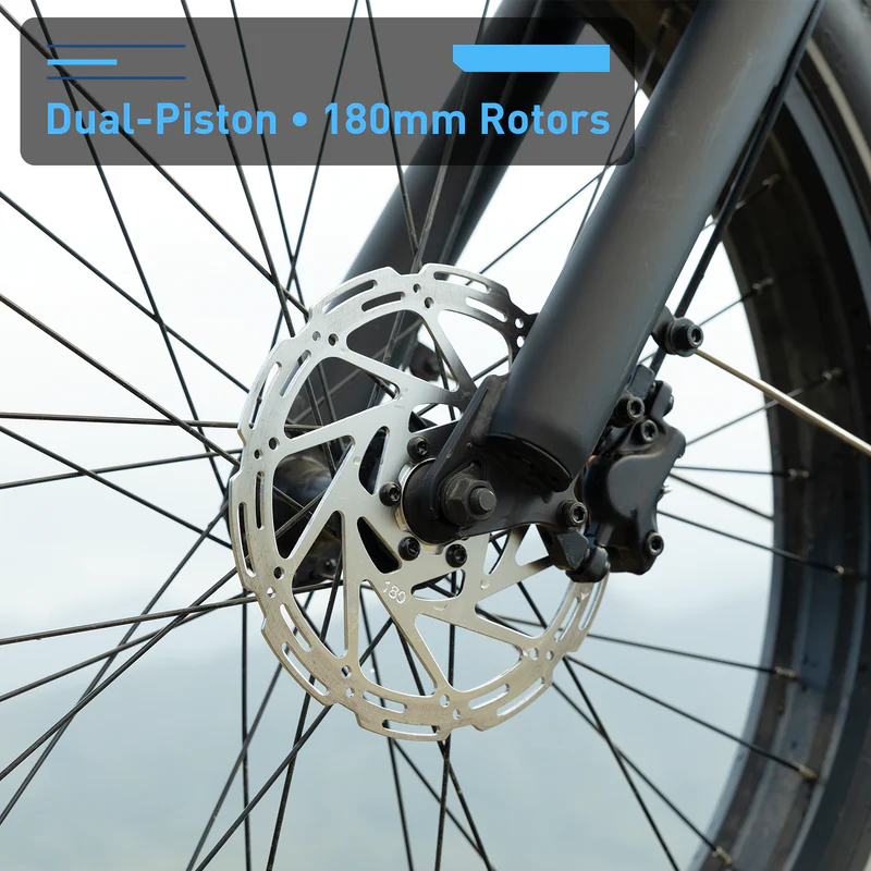 Close-up of the Hiboy - EX11's front wheel, showing its dual-piston brakes with a 180mm rotor and full suspension electric bike design, with highlighted text to showcase these premium Hiboy features.